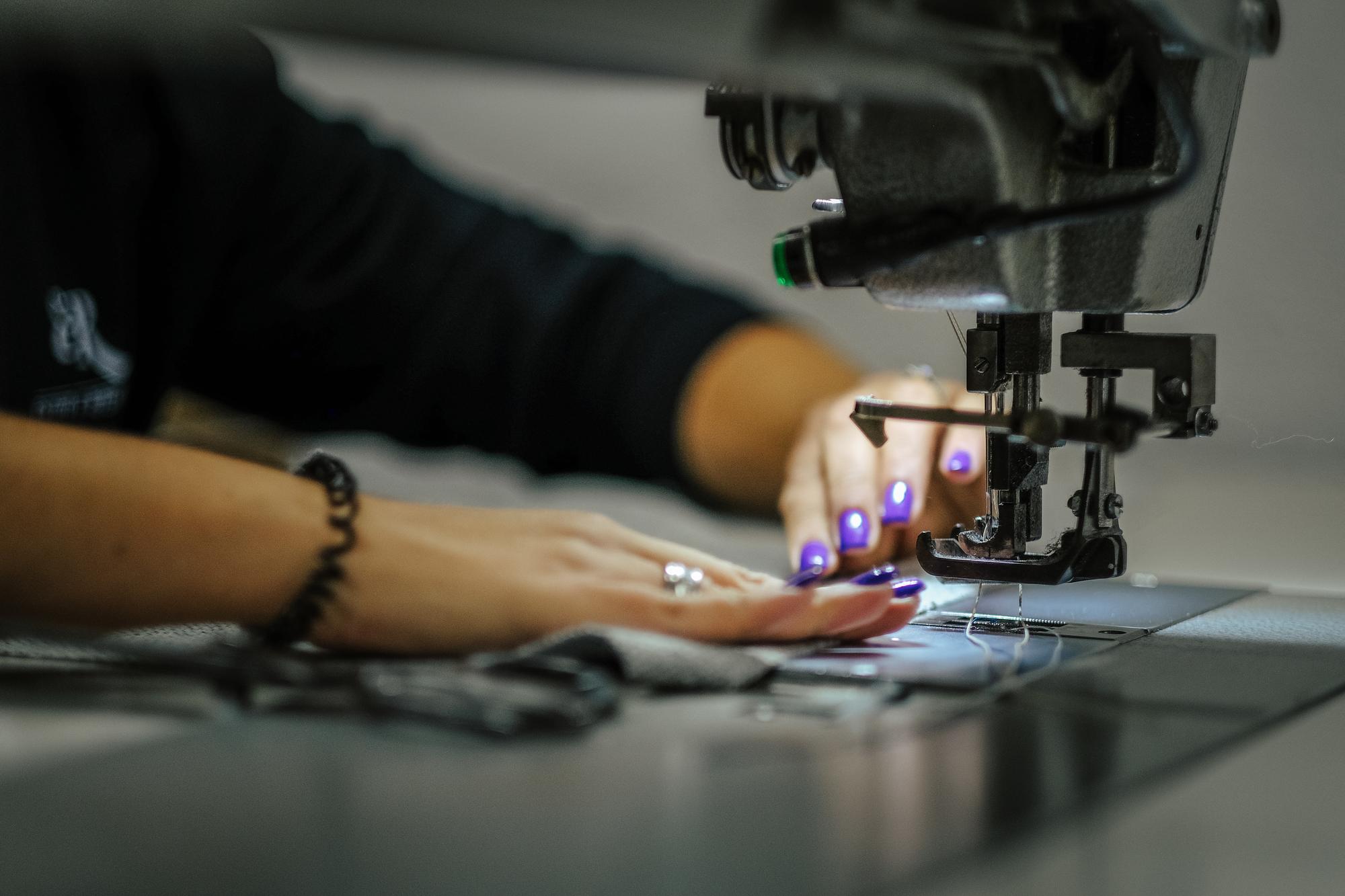 Designer calibrating embroidery machine