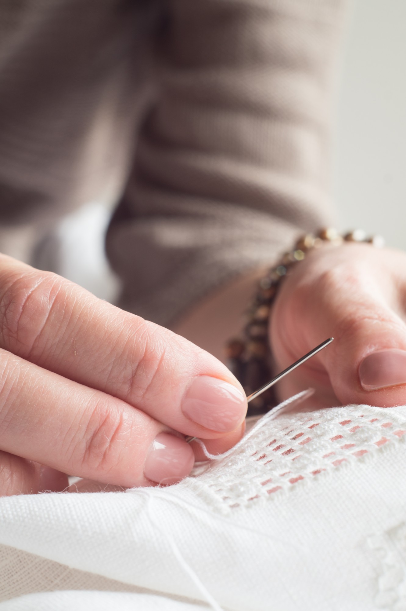 Workshop hands stitching delicate pattern